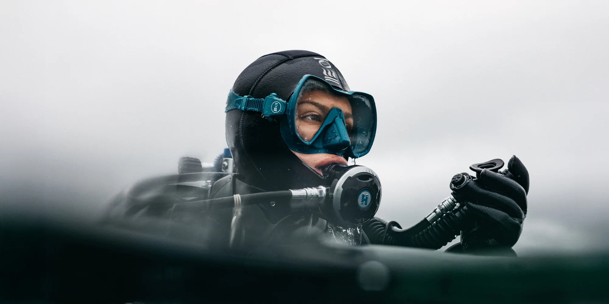scuba diver in Fourth Element Dive gear, wearing the new Seeker Mask in Teal 